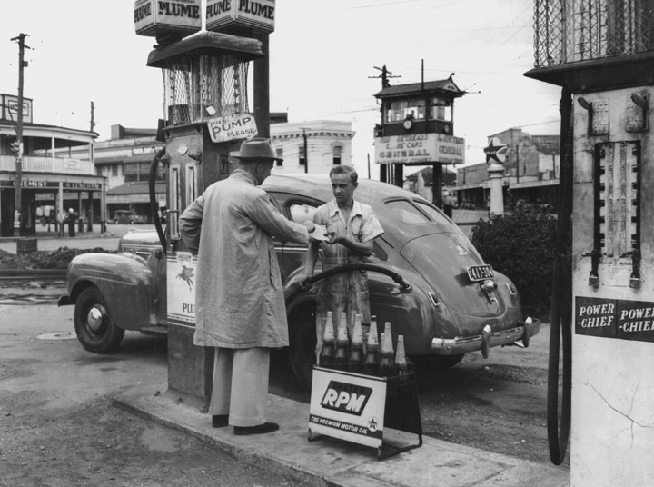 Filling the car with rationed petrol, Woolloongabba, 1949